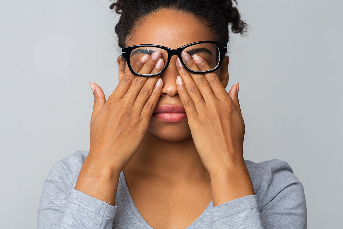 African girl in glasses rubs her eyes suffering from tired eyes African girl in glasses rubs her eyes suffering from tired eyes
