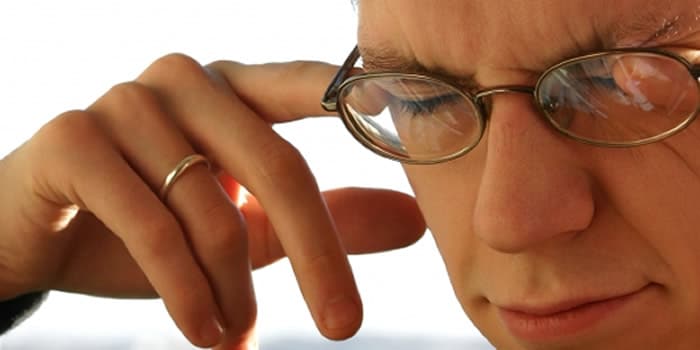 man scratching eyelid man scratching eyelid