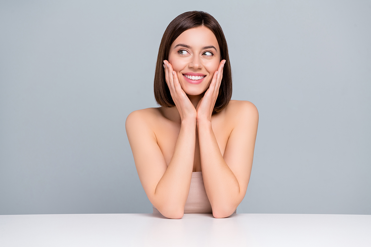 Photo of lady sit table touch hands cheeks