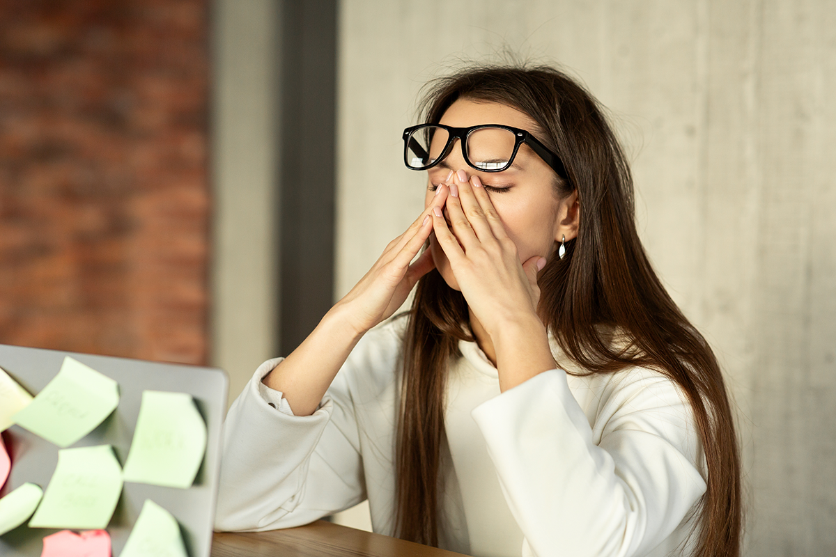 Tired girl trying to concentrate, her eyes are dry