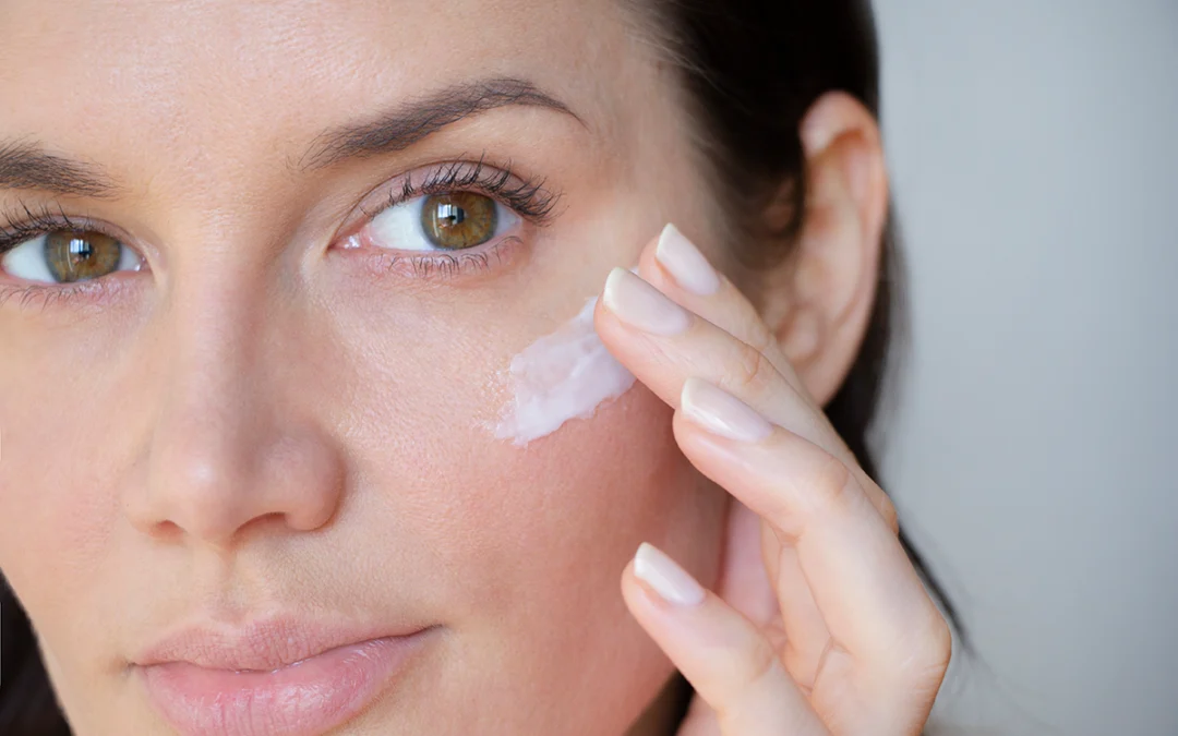 Woman applies wrinkle cream on lower eyelid