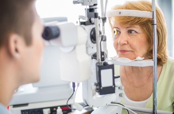 woman getting eyes analyzed woman getting eyes analyzed