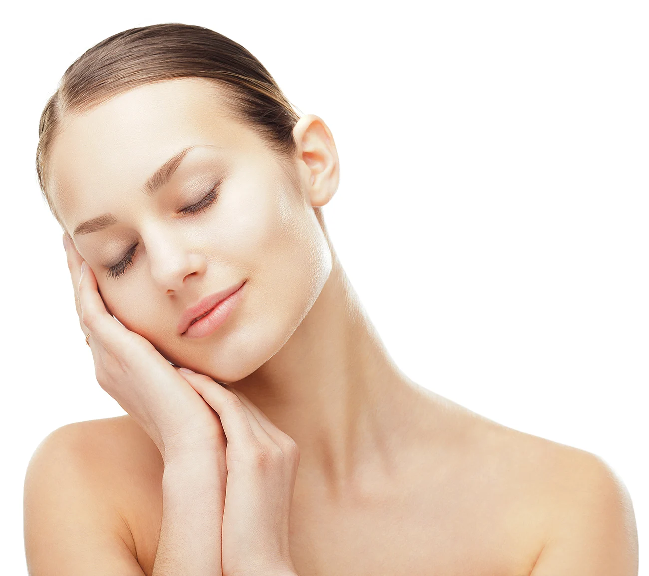 Woman with clear glowing skin resting her face on her hands against a white background.
